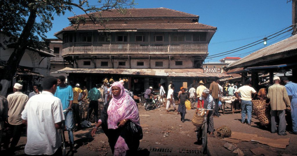 Local people on a street in Stone Town, the old part of Zanzibar City, the capital of Zanzibar.